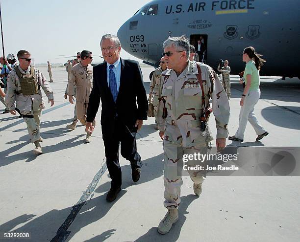 Secretary of Defense Donald Rumsfeld walks with U.S. Army General George Casey after arriving at the Baghdad International Airport July on 27, 2005...
