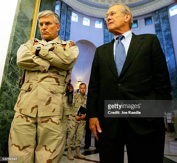 Army General George Casey stands with U.S. Secretary of Defense Donald Rumsfeld during a press conference on July 27, 2005 in Baghdad, Iraq. Rumsfeld...