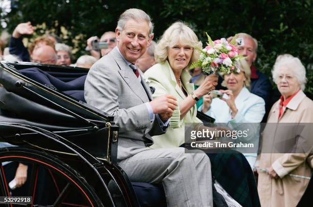 Prince Charles, the Prince of Wales, and his wife Camilla, the Duchess of Cornwall, ride in an open carriage after a visit to the Sandringham Flower...