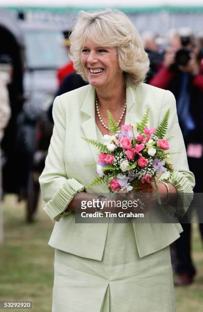 Camilla, the Duchess of Cornwall, holds flowers during her visit to the Sandringham Flower Show on July 27, 2005 in Sandringham, Norfolk.