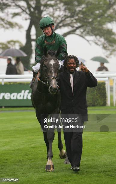 Mick Kinane and Proclamation return after landing The Cantor Spreadfair Sussex Stakes Race run at Goodwood Racecourse on July 27, 2005 in Goodwood,...