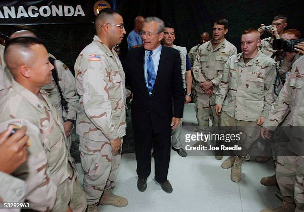 Secretary of Defense Donald Rumsfeld shakes hands with U.S. Army soldiers during a town hall-style meeting July 27, 2005 at the Balad airbase in...