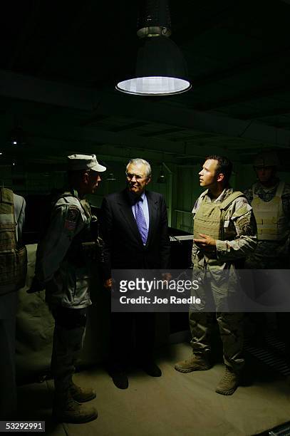 Secretary of Defense Donald Rumsfeld meets with U.S. Lt. Gen. Dave Petraeus and Iraqi Army soldiers during a counter-terrorism force demonstration...