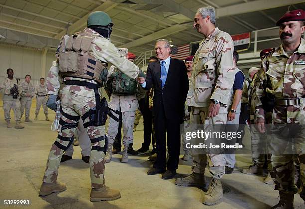 Secretary of Defense Donald Rumsfeld greets an Iraqi soldier during a counter-terrorism force demonstration July 27, 2005 in Baghdad, Iraq. Rumsfeld...