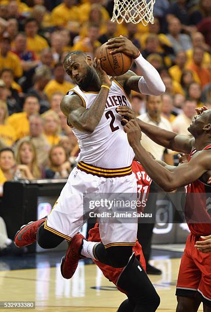 LeBron James of the Cleveland Cavaliers battles for the ball against Bismack Biyombo of the Toronto Raptors during the first half in game two of the...