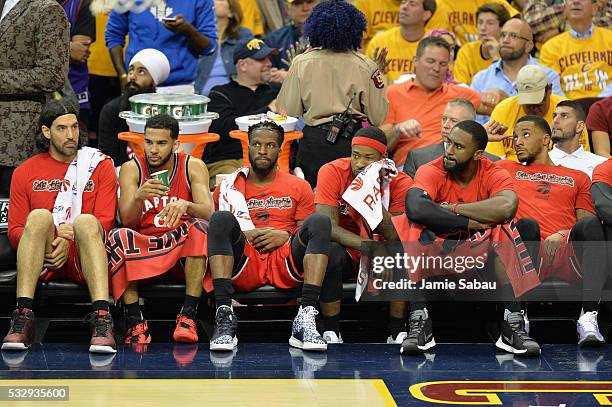 Luis Scola of the Toronto Raptors, Cory Joseph, DeMarre Carroll, Terrence Ross, Patrick Patterson, and Norman Powell react on the bench during the...