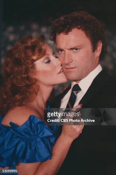American actress Kim Lankford kisses Kevin Dobson during the episode 'Catharsis' of the CBS prime time soap opera 'Knot's Landing,' October 28, 1982.
