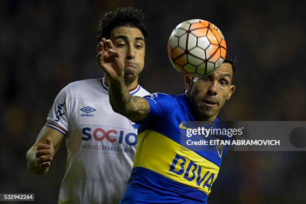 Argentina's Boca Juniors forward Carlos Tevez vies for the ball with Uruguay's Nacional defender Jorge Fucile during the Libertadores Cup...