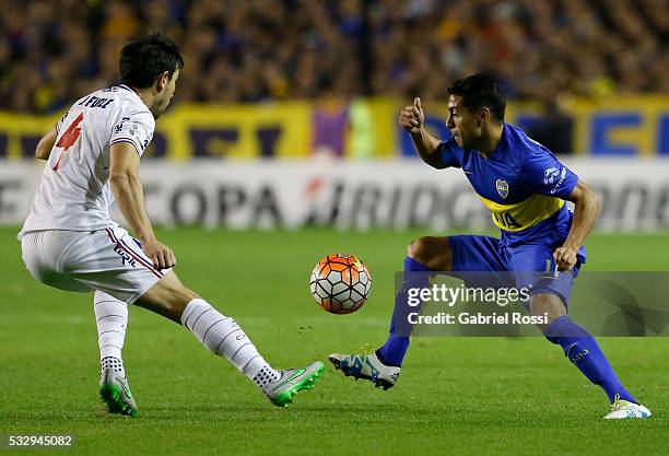 Federico Carrizo of Boca Juniors fights for the ball with Jorge Fucile of Nacional during a second leg match between Boca Juniors and Nacional as...
