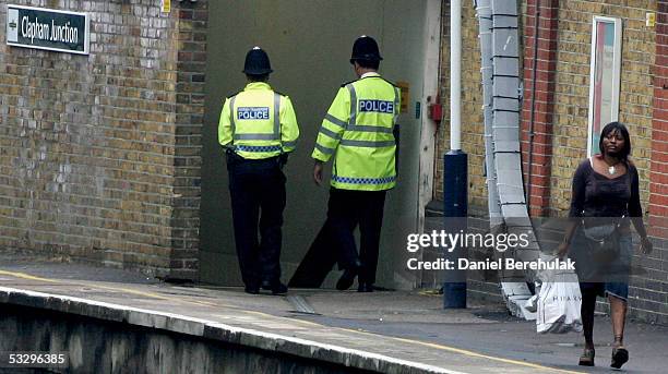 Police patrol Clapham Junction train Station on July 28, 2005 in London, England. A major police operation is under way on the UK's transport system,...