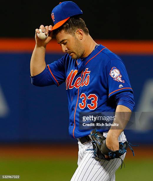 Pitcher Matt Harvey of the New York Mets reacts after giving an RBI triple to Ben Revere of the Washington Nationals during the third inning of a...