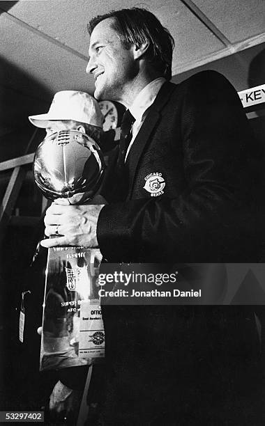 Team President Michael McCaskey of the Chicago Bears holds the Vince Lombardi Trophy in the locker room following Super Bowl XX against the New...