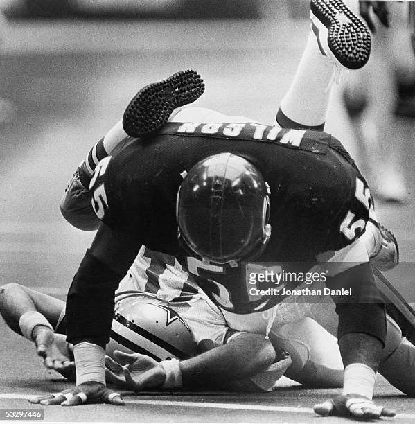 Otis Wilson of the Chicago Bears knocks Danny White of the Dallas Cowboys out of the game after landing on top of him during the game at Texas...