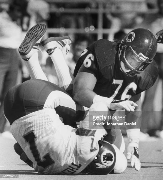 Steve McMichael of the Chicago Bears sacks Joe Theismann of the Washington Redskins during the game at Soldier Field on September 29, 1985 in...
