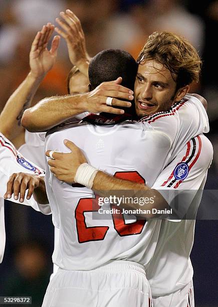 Clarence Seedorf hugs teammate Alberto Gilardino of AC Milan during their international friendly match against the Chicago Fire on July 27, 2005 at...