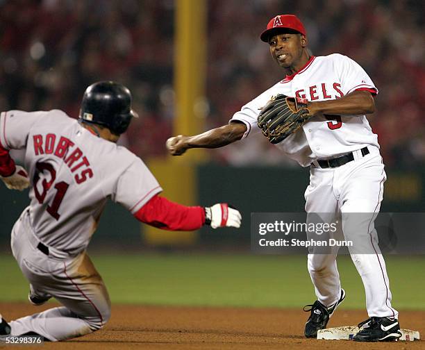 Third baseman Chone Figgins of the Anaheim Angels throws the ball after tagging out outfielder Dave Roberts during the American League Division...