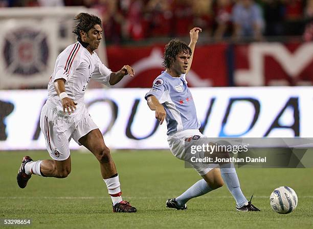 Manuel Rui Costa of AC Milan chases after the ball as Logan Pause of the Chicago Fire forwards a pass during their friendly match on July 27, 2005 at...