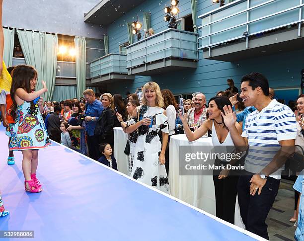 Mario Lopez and wife Courtney Lopez cheer on their daughter Gia Lopez during the fashion debut of the Disney Pixar 'Finding Dory' collection from...