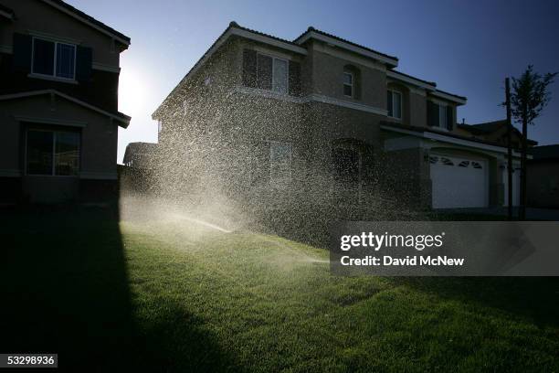 Sprinklers water the lawns of a new housing development July 28, 2005 in Hesperia, California. California's demand for water will jump by 40 percent...