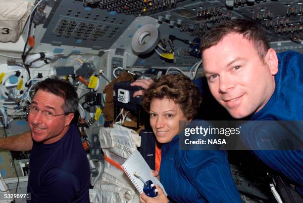 In this handout photo provided by NASA, Discovery's crew members Eileen M. Collins , STS-114 commander, flanked by astronauts Stephen K. Robinson...