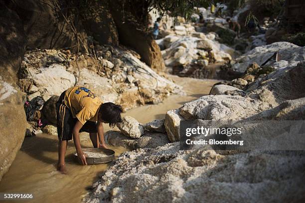 Man uses a sieve to pan for gemstones at a stream in Mogok, Mandalay, Myanmar, on Monday, March 14, 2016. In a remote region of Myanmar, a country...