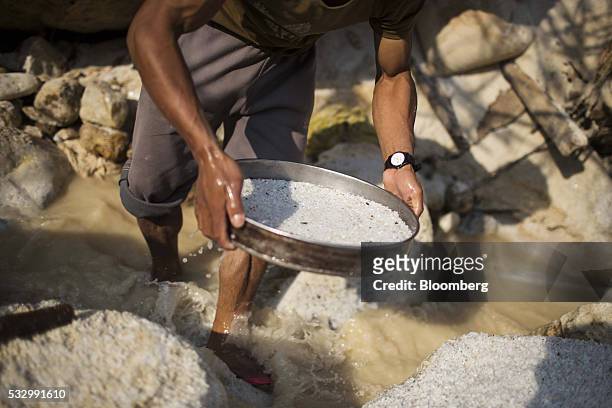 Man uses a sieve to pan for gemstones at a stream in Mogok, Mandalay, Myanmar, on Monday, March 14, 2016. In a remote region of Myanmar, a country...