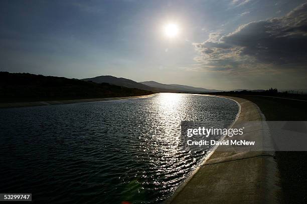 The California Aqueduct, which carries water hundreds of miles from northern California to the state's southern cities, flows through the desert on...