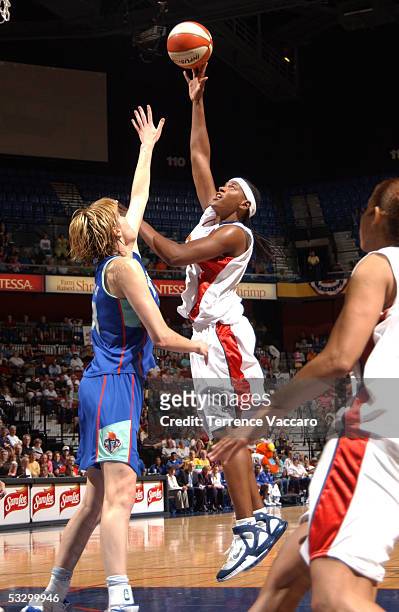 Asjha Jones of the Connecticut Sun goes to the basket against Elena Baranova of the New York Liberty during the game at Mohegan Sun on July 28, 2005...