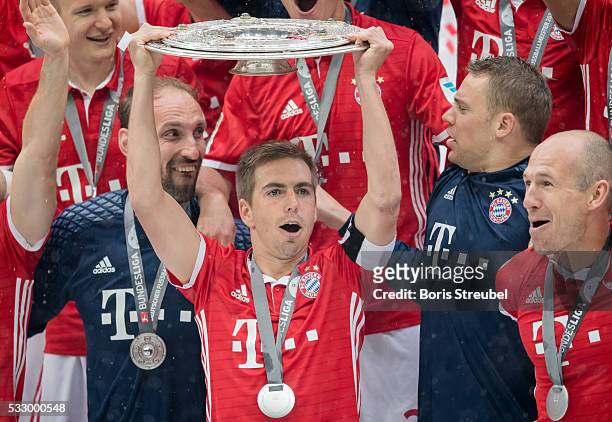 Philipp Lahm of Muenchen lifts the Meisterschale as players and staffs celebrate the Bundesliga championship after the Bundesliga match between FC...