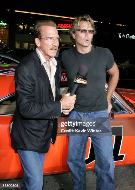 The Insider TV personality Pat O'Brien interviews actor John Schneider as he arrives at the Premiere Of "The Dukes of Hazzard" at the Grauman's...