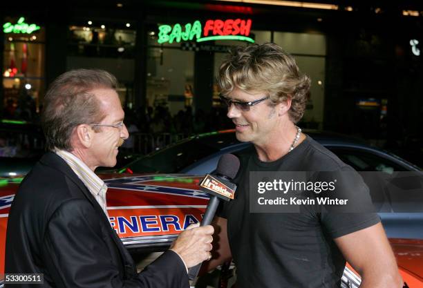 The Insider TV personality Pat O'Brien interviews actor John Schneider as he arrives at the Premiere Of "The Dukes of Hazzard" at the Grauman's...