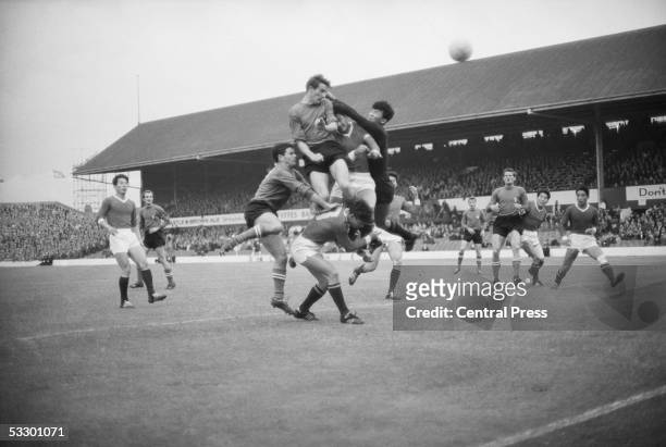 North Korean goalkeeper Li Chan Myung clears while Romano Fogli and Marino Perani of Italy with North Korea's Oh Yoon Kyung all go up for the ball at...