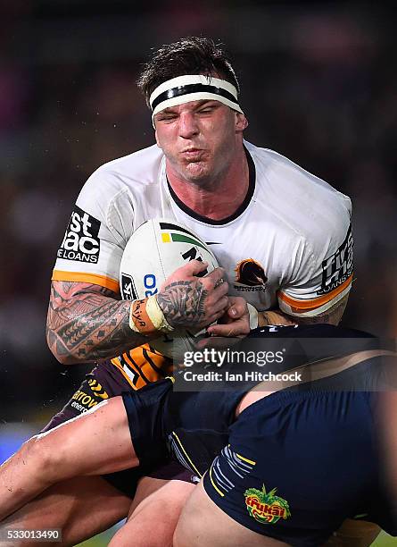 Josh McGuire of the Broncos is tackled by Ben Hannant of the Cowboys during the round 11 NRL match between the North Queensland Cowboys and the...