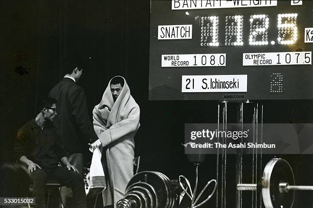 Shiro Ichinoseki of Japan prepare to compete in the Weightlifting Bantamweight during the Tokyo Summer Olympic Games at the Shibuya Kokaido Hall on...