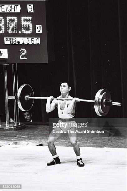 Shiro Ichinoseki of Japan competes in the Weightlifting Bantamweight during the Tokyo Summer Olympic Games at the Shibuya Kokaido Hall on October 11,...