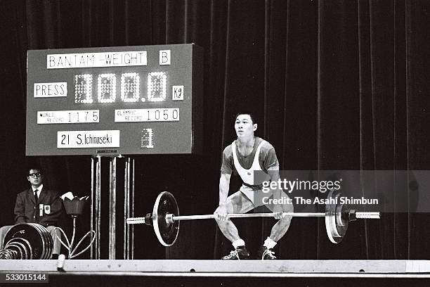 Shiro Ichinoseki of Japan competes in the Weightlifting Bantamweight during the Tokyo Summer Olympic Games at the Shibuya Kokaido Hall on October 11,...