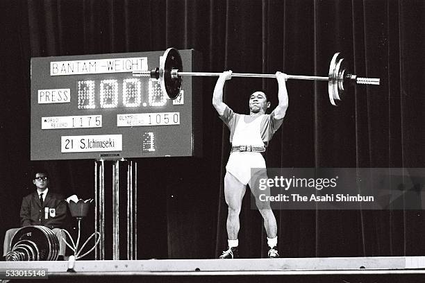 Shiro Ichinoseki of Japan competes in the Weightlifting Bantamweight during the Tokyo Summer Olympic Games at the Shibuya Kokaido Hall on October 11,...