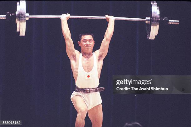 Shiro Ichinoseki of Japan competes in the Weightlifting Bantamweight during the Tokyo Summer Olympic Games at the Shibuya Kokaido Hall on October 11,...