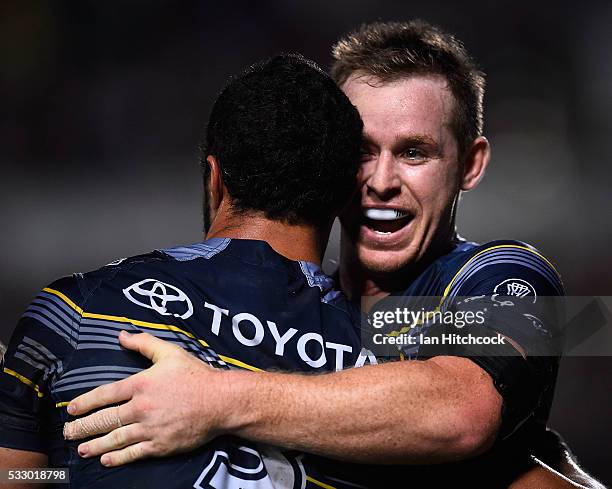 Justin O'Neil of the Cowboys celebrates after scoring a try with Michael Morgan during the round 11 NRL match between the North Queensland Cowboys...