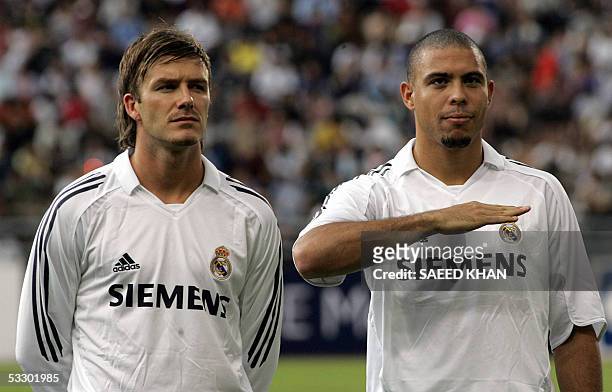 Real Madrid's midfielder David Beckham of England and team-mate Ronaldo Luiz wait for the playing of the national anthems prior to an exhibition...