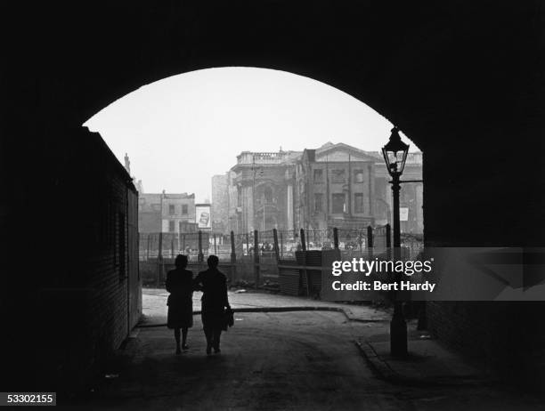 Two people emerge from under a bridge at Elephant And Castle, south London, 8th January 1949. Original Publication : Picture Post - 4694 - Life In...