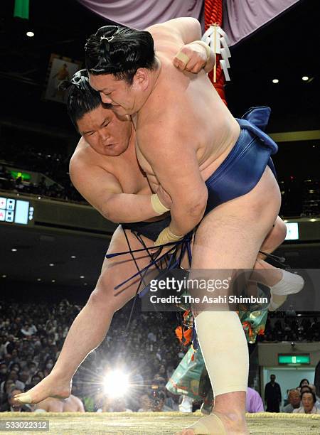 Ozeki Goeido throws sekiwake Ikioi to win during day thirteen of the Grand Sumo Summer Tournament at the Ryogoku Kokugikan on May 20, 2016 in Tokyo,...