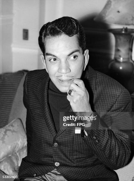 Mexican comedian Cantinflas looks thoughtful as he sits in his London hotel room before meeting actors for casting in his new film 'Pepe,' London,...