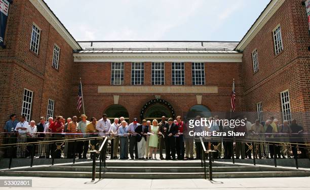 Members of the Baseball Hall of Fame, along with board members and state senators cut a ribbon during a rededication ceremony at the National...