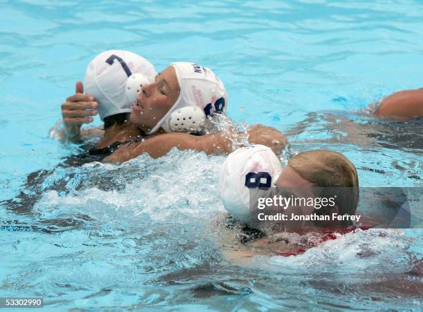 Ann Dow hugs teammate Cora Campbell of Canada as head coach Patrick Oaten hugs Dominique Perrault of Canada after they defeated Russia in the bronze...