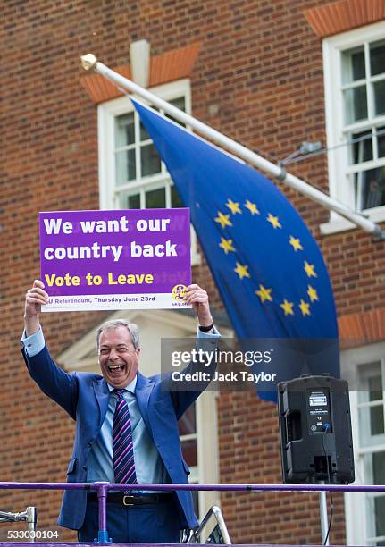 Leader of the United Kingdom Independence Party Nigel Farage poses with a placard on top of a campaign bus parked outside Europe House in Westminster...
