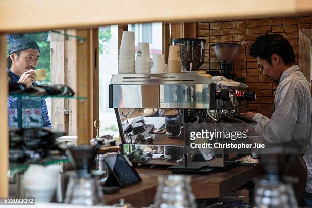 Customer drinks coffee at specialty coffee shop Onibus Coffee on May 20, 2016 in Tokyo, Japan. With the rise of specialty coffee shops opening all...