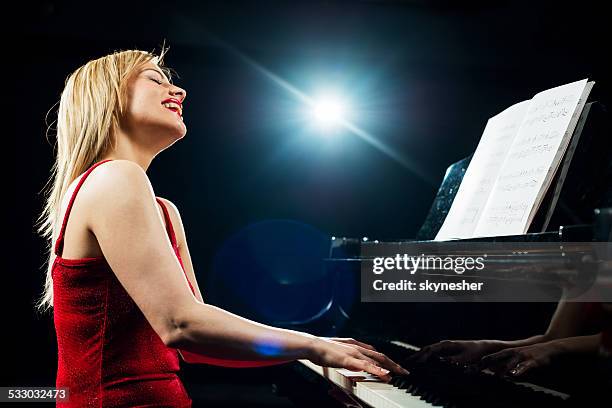 happy woman playing piano. - jazz concert stock pictures, royalty-free photos & images