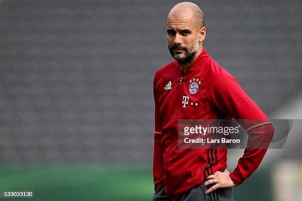 Head coach of Bayern Muenchen Josep Guardiola looks on during the Bayern Muenchen final training session ahead of the DFB Cup Final 2016 at...