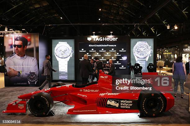 Kilian Muller, chief executive officer of TAG Heuer North America, center, speaks with attendees at the company's booth during the 2016 TimeCrafters...